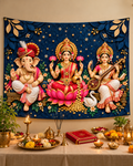 Ganesh Laxmi Saraswati tapestry hung as a pooja backdrop above a mandir table