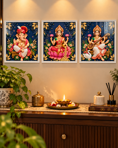 Ganesh, Laxmi and Saraswati posters in white frames