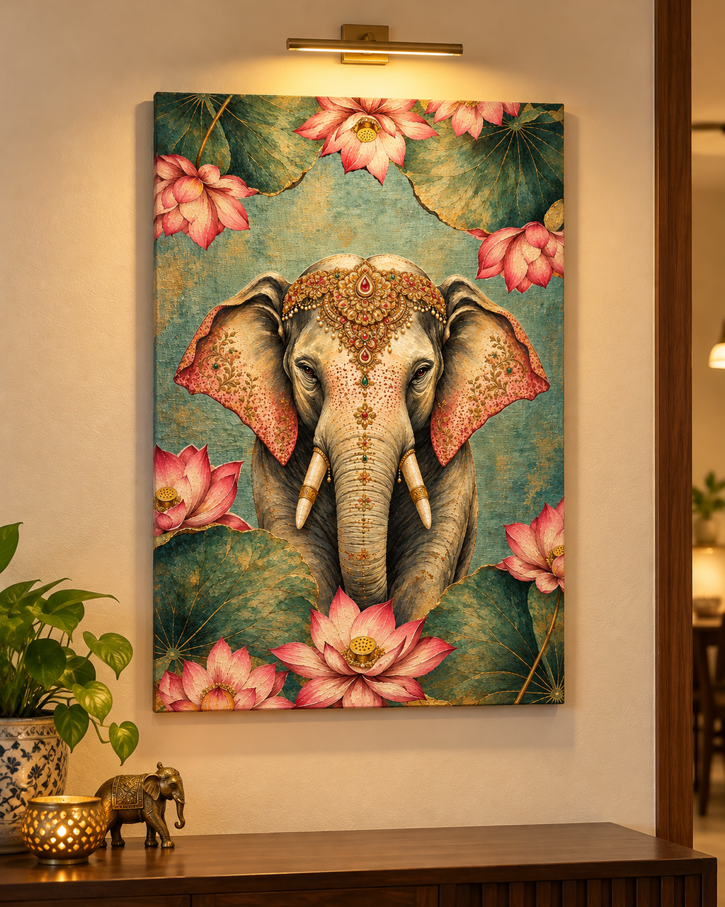 Ornate Lotus Elephant canvas on a beige wall with a brass picture light and potted plant
